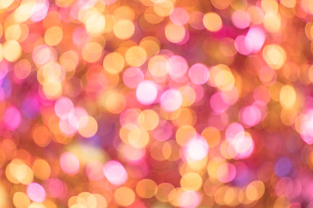 istock Background texture full of unsharp golden and pink shining bokeh blurring gradation design. 1050825546