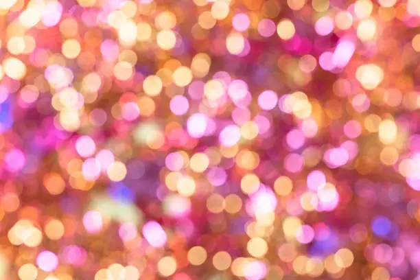 Photo of Background texture full of unsharp golden and pink shining bokeh blurring gradation design.