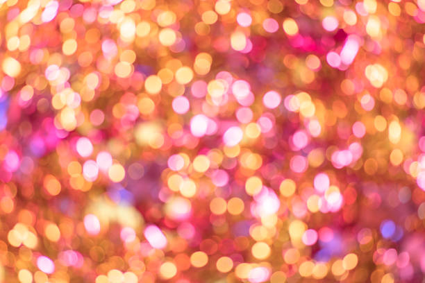 istock Background texture full of unsharp golden and pink shining bokeh blurring gradation design. 1050825562