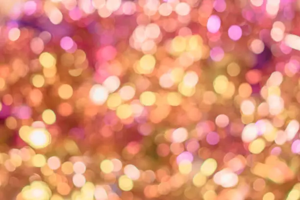Photo of Background texture full of unsharp golden and pink shining bokeh blurring gradation design.