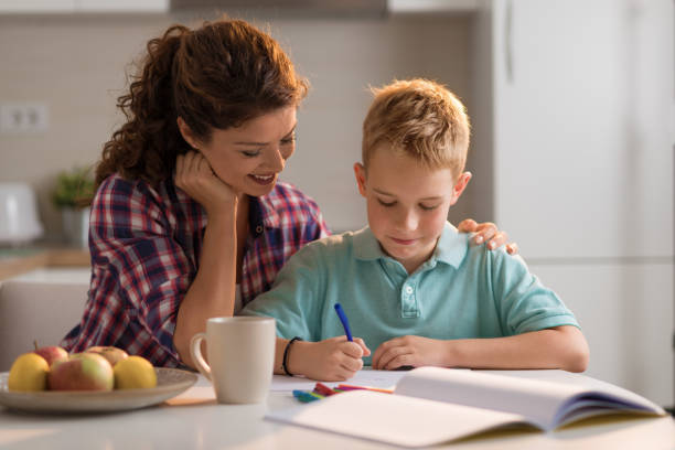 istock Little boy sketching with his mother at home 1050835674
