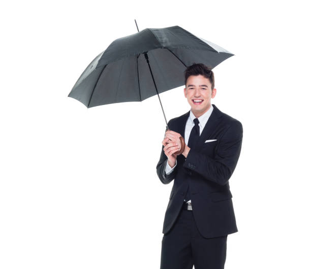istock Handsome businessman holding an umbrella 1050836712