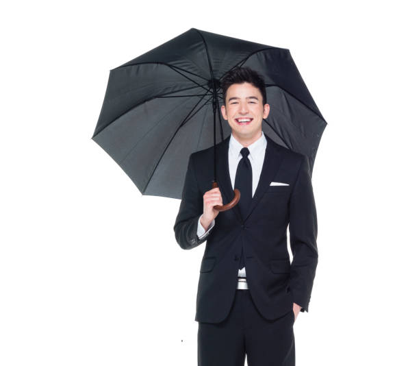 istock Handsome businessman holding an umbrella 1050838230