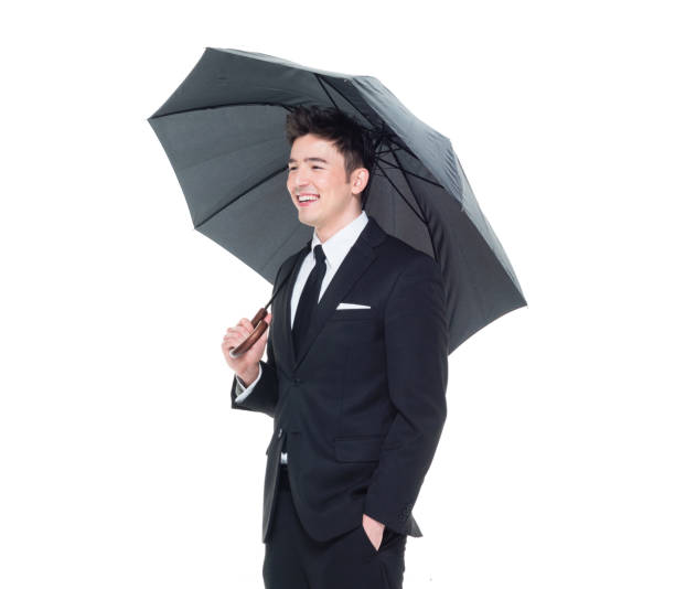 istock Handsome businessman holding an umbrella 1050838238