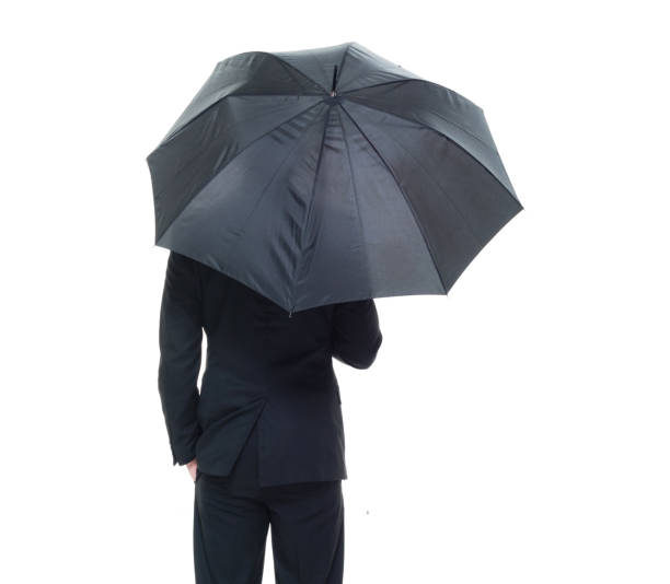 istock Handsome businessman holding an umbrella 1050838240