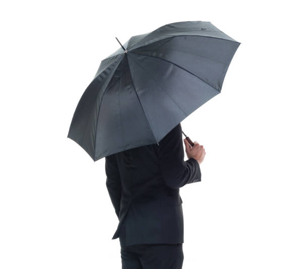 istock Handsome businessman holding an umbrella 1050838270