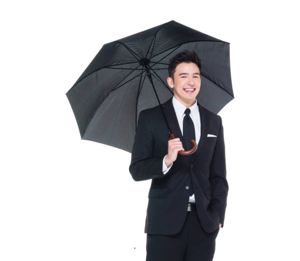istock Handsome businessman holding an umbrella 1050838282