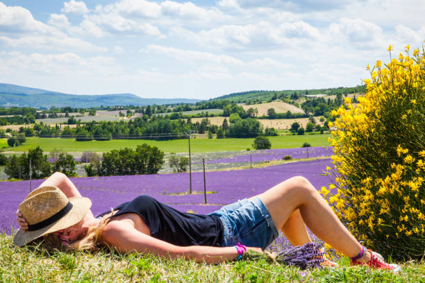 Woman relaxing in a lavender field
