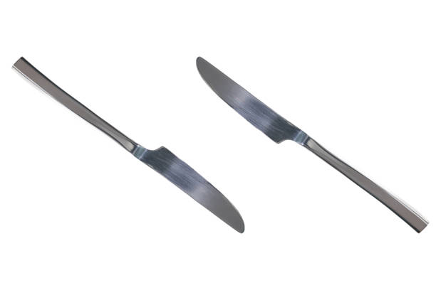 Two shiny knives. Isolated white background. Concept design. Copy space