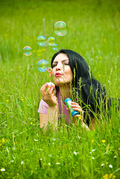 istock Lying in field and blowing soap bubbles 105083864