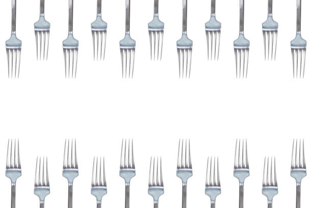 Close up image depicting the contents of the cutlery drawer - forks, knives, spoons - in a domestic kitchen.