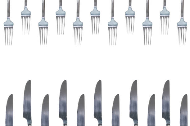 istock Many silver shiny forks and knives. Isolated white background. Concept copy space design. 1050839192