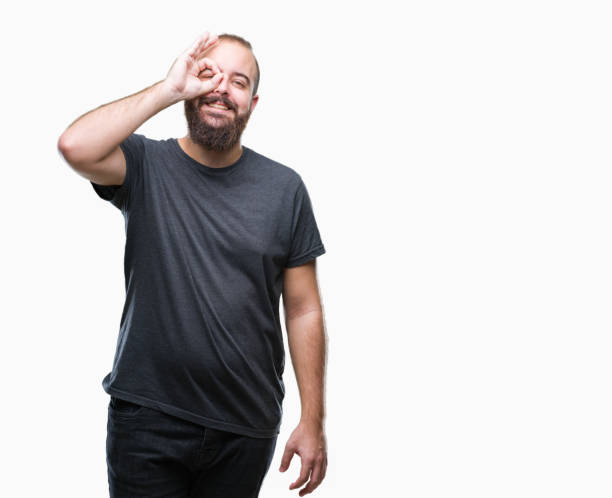 istock Young caucasian hipster man over isolated background doing ok gesture with hand smiling, eye looking through fingers with happy face. 1050839280