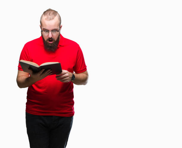 istock Young hipster man wearing glasses and reading a book over isolated background scared in shock with a surprise face, afraid and excited with fear expression 1050839366