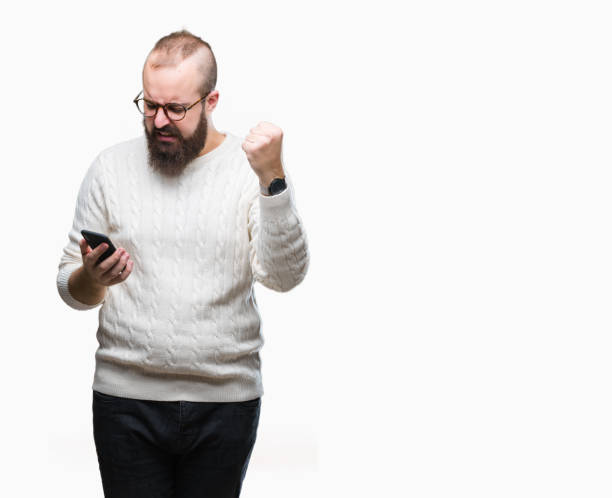 istock Young caucasian hipster man texting sending message using smartphone over isolated background annoyed and frustrated shouting with anger, crazy and yelling with raised hand, anger concept 1050839446