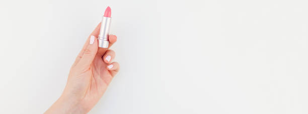 istock Woman hand with pink lipstick 1050843654