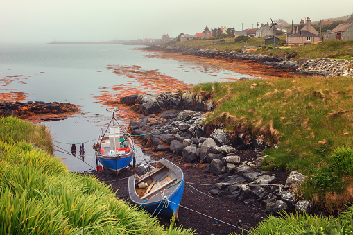 Small fishing boats on a foggy morning in Berneray, North Uist, Outer Hebrides, Scotland, United Kingdom