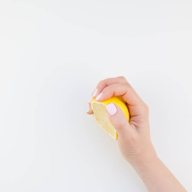 istock Woman hand with lemon 1050846302