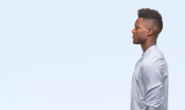 istock Young african american man over isolated background looking to side, relax profile pose with natural face with confident smile. 1050848066