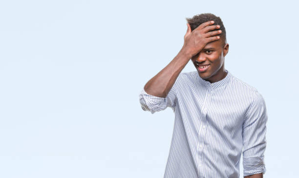 istock Young african american man over isolated background surprised with hand on head for mistake, remember error. Forgot, bad memory concept. 1050848078