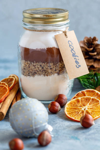 istock Glass jar with ingredients for baking chocolate nut cookies. 1050848200