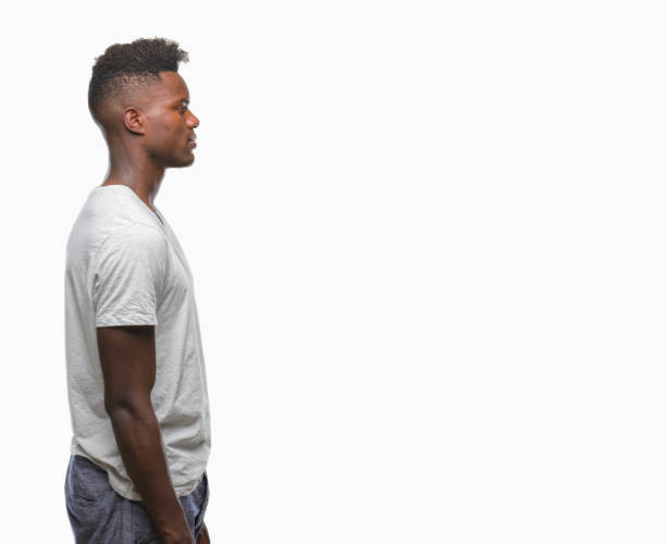 istock Young african american man over isolated background looking to side, relax profile pose with natural face with confident smile. 1050850800