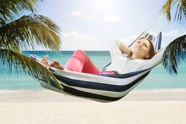 istock Smiling Woman Relaxing In Hammock 1050851086