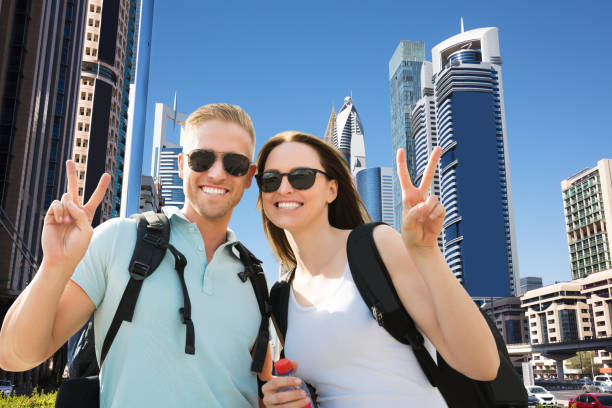 istock Happy Couple Gesturing Peace Sign 1050851168