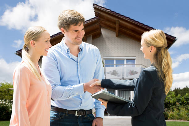 istock Estate Agent Shaking Hands With Young Couple 1050851252