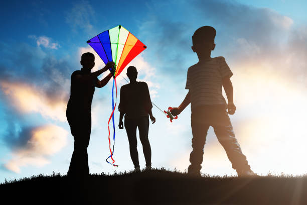 istock Family Playing With The Colorful Kite 1050851346