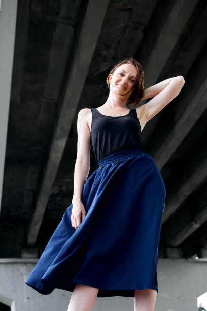 istock young girl posing under the bridge, dressed in black, modern architecture 1050851568