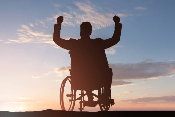 istock Young Disabled Man On Wheelchair With Arm Raised 1050851794