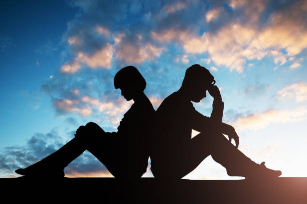 istock Silhouette Of Sad Couple Sitting Back To Back 1050851820