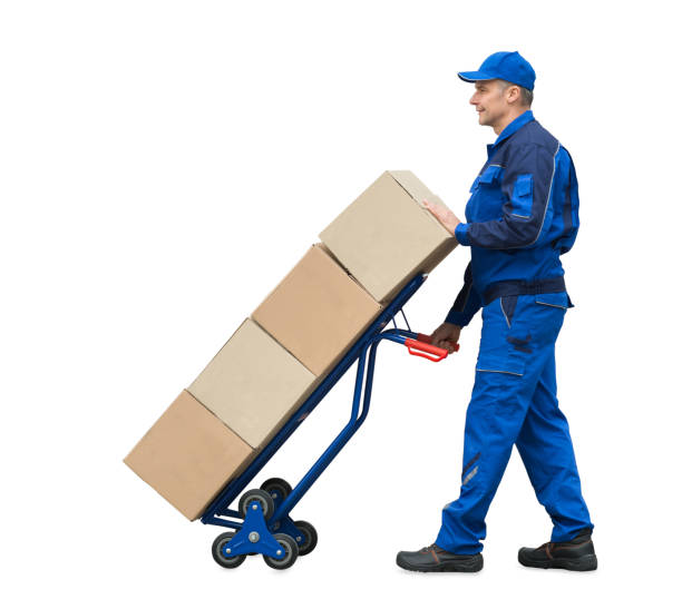 istock Delivery Man Carrying Cardboard Boxes On Hand Truck 1050851890