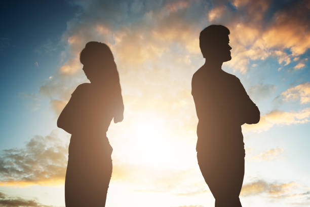 istock Silhouette Of A Unhappy Couple Standing Back To Back 1050851938