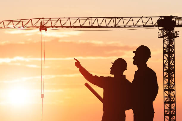 istock Silhouette Of An Architect Showing Something To His Partner 1050851946