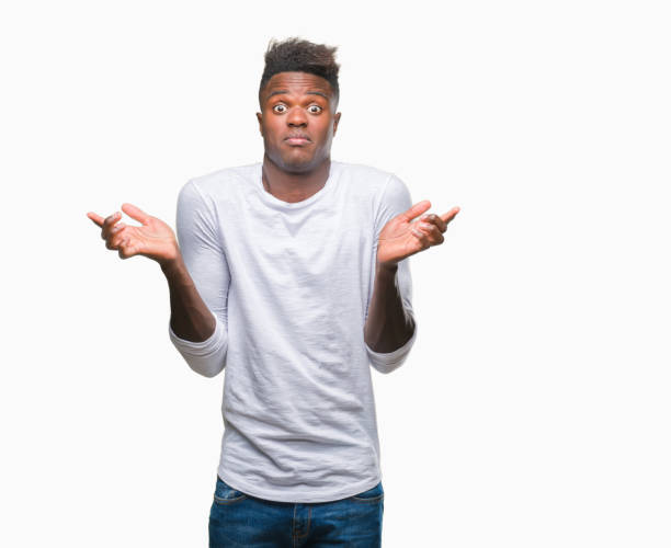 istock Young african american man over isolated background clueless and confused expression with arms and hands raised. Doubt concept. 1050852068