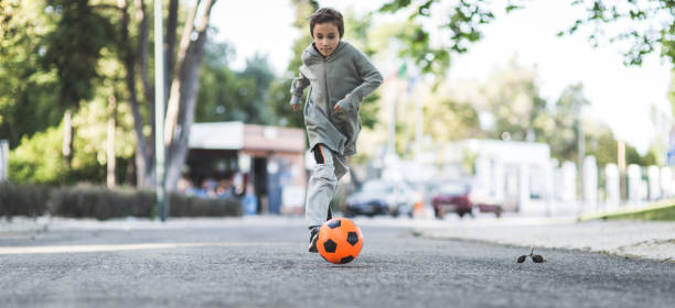 istock Boy play with football ball 1050854900