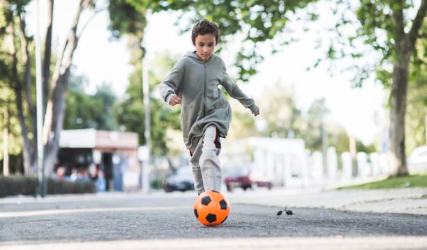 istock Boy play with football ball 1050854922