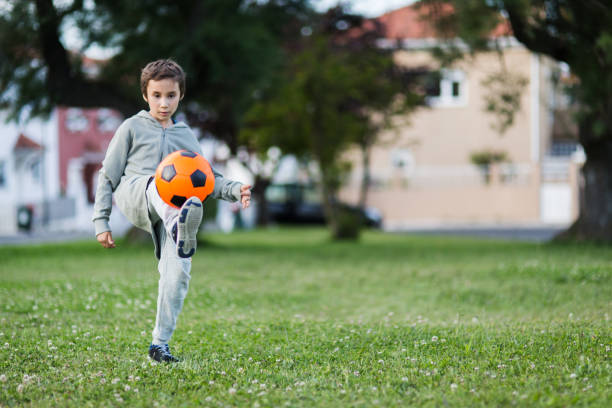 istock Boy play with football ball 1050854934