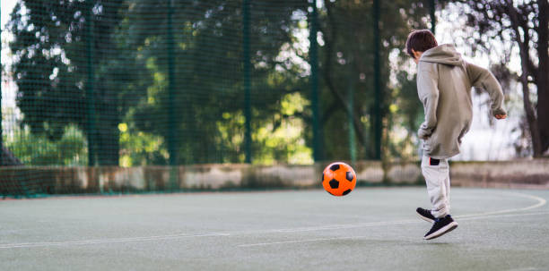 istock Boy play with football ball 1050854962