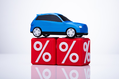 Blue Car Over Cubic Blocks With Red Percentage Sign On White Background