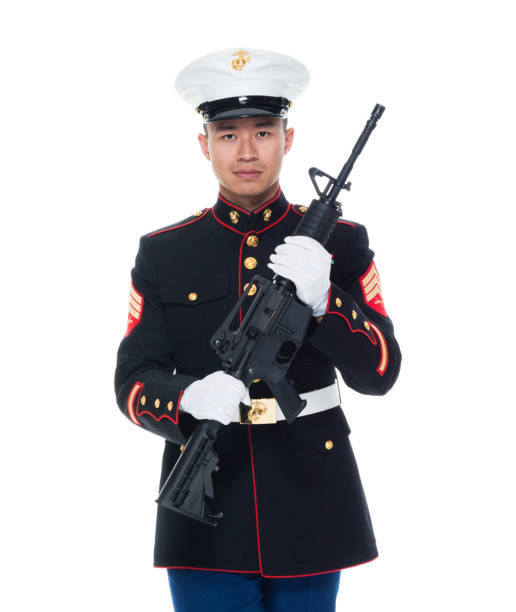 US Marine in uniform holding rifle