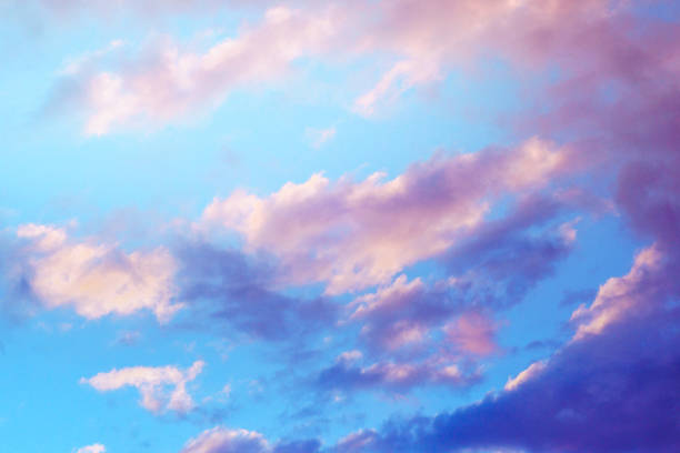 istock beautiful blue sky with purple clouds and sunlight at sunset 1050859160