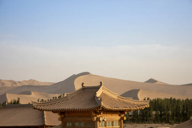 istock Landscape with rooftops and Singing Sand Mountain, Dunhuang, China 1050864160
