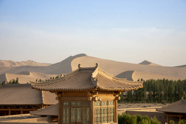 istock Pagoda rooftops and Singing Sand Mountain, Dunhuang, China 1050865074