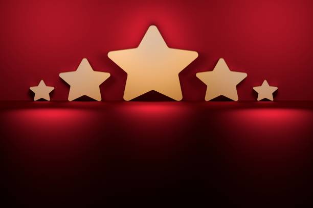 Five stars of various size next to the purple dark red wall. stock photo