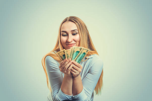 istock Excited woman with money bills 1050875506