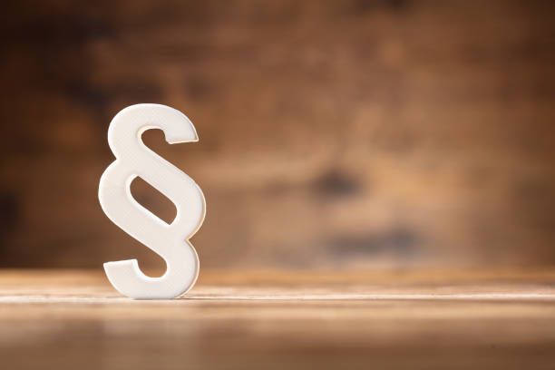 Close-up Of A White Paragraph Symbol Close-up Of A White Paragraph Symbol On Wooden Desk paragraph photos stock pictures, royalty-free photos & images