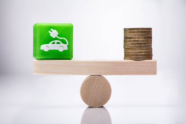 istock Eco Car Icon Cubic Block And Coins Balancing On Seesaw 1050882016